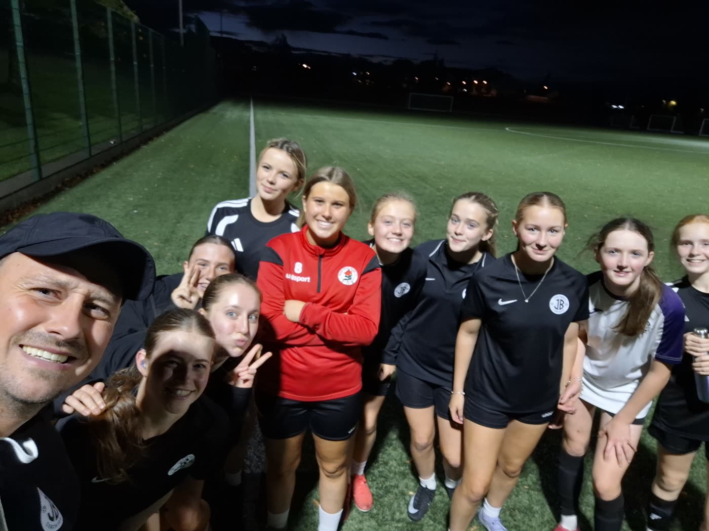 Jonathan with his players under the lights